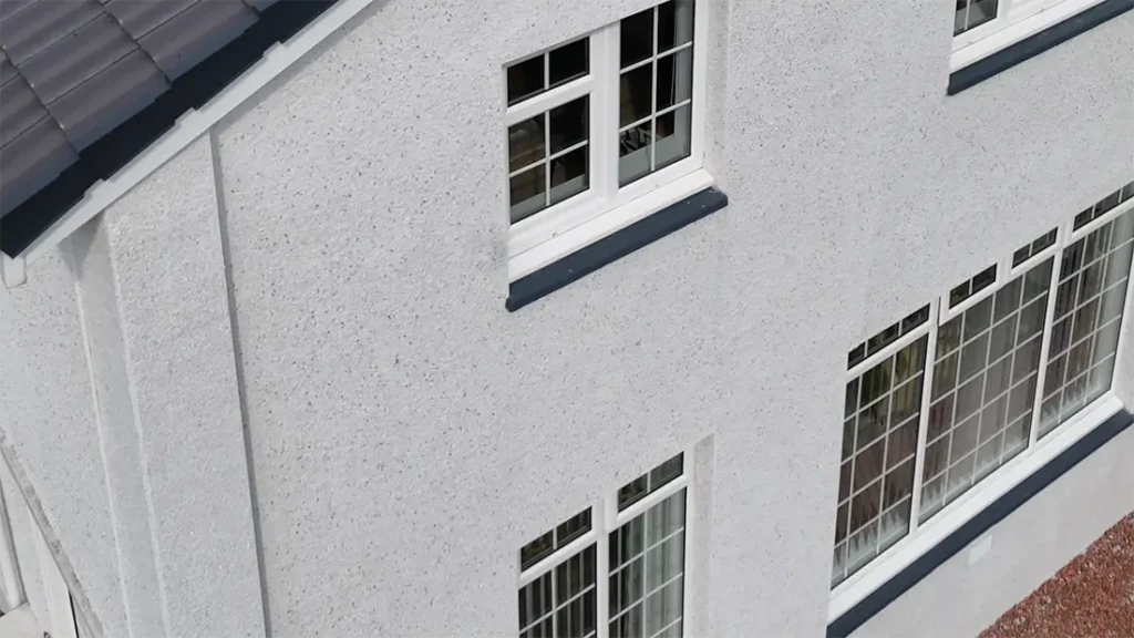 Close-up of newly applied grey roughcast render on a house exterior in Lenzie, Scotland, by Speedy Roofing
